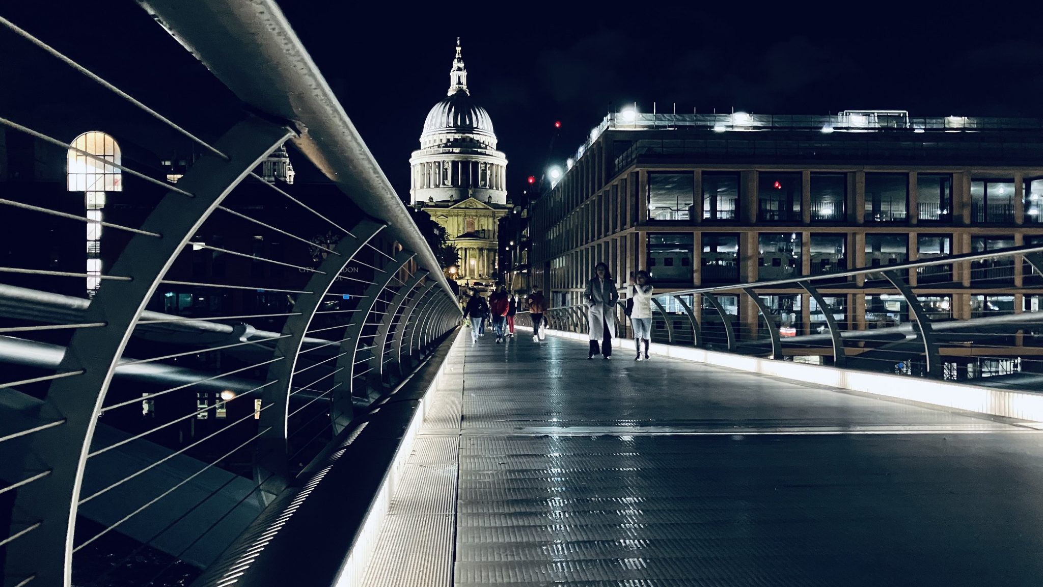 Pedestrians cross Millennium Bridge after its reopening.
