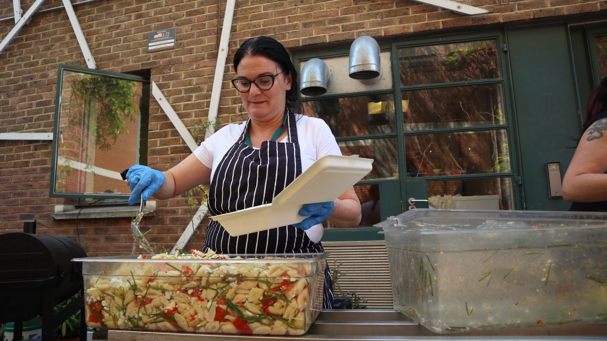Providence Row employee Maria O’Donoghue serving food at the charity’s day centre off Brick Lane