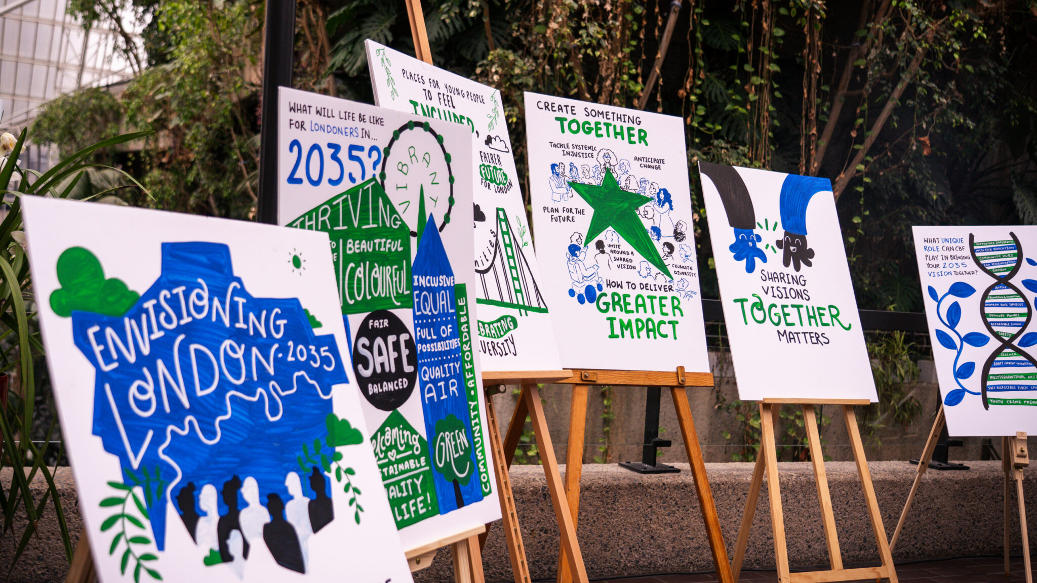 A row of illustrated boards on easels showing people’s ideas for London in 2035, created at City Bridge Foundation’s Envisioning London event.