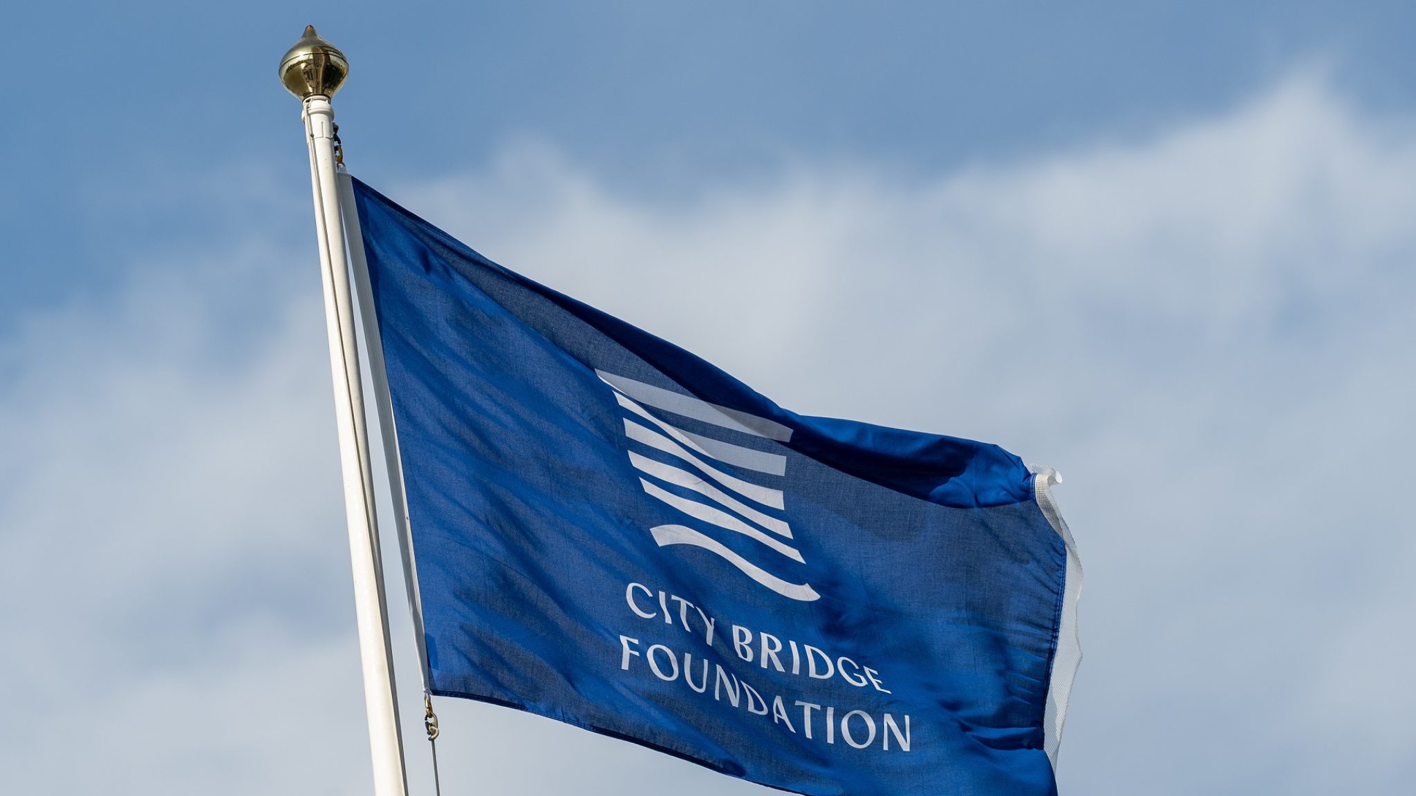 The new City Bridge Foundation flag flies over Tower Bridge