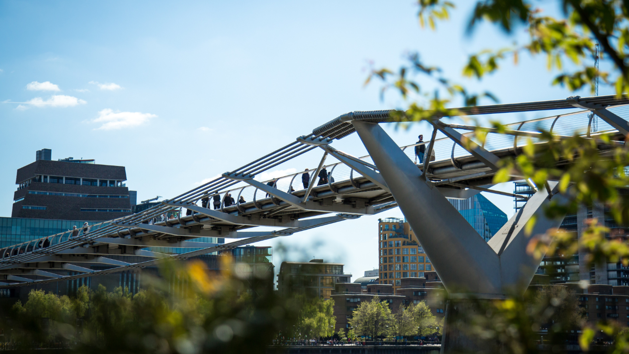 Photo of Millennium Bridge, taken from beneath with the sky as a backdrop